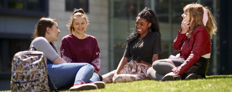 BMet students_relaxing_on_grass